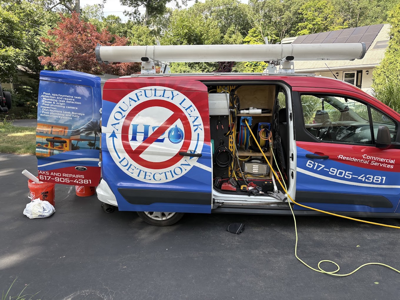Aquafully Leak Detection service van with company branding parked at a job site